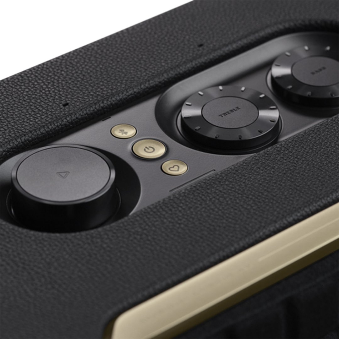 Close up of the top panel of a black portable speaker with controls