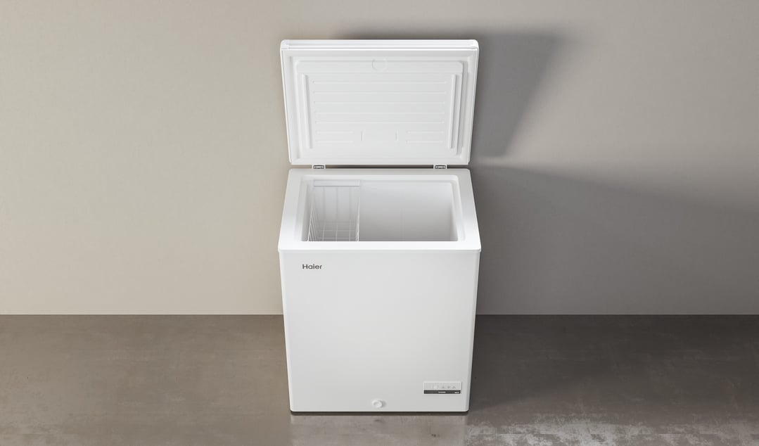 White Haier chest freezer with the lid open, in a room