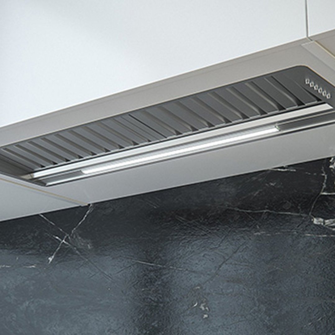Undermount rangehood installed above a black marble backsplash in a kitchen setting