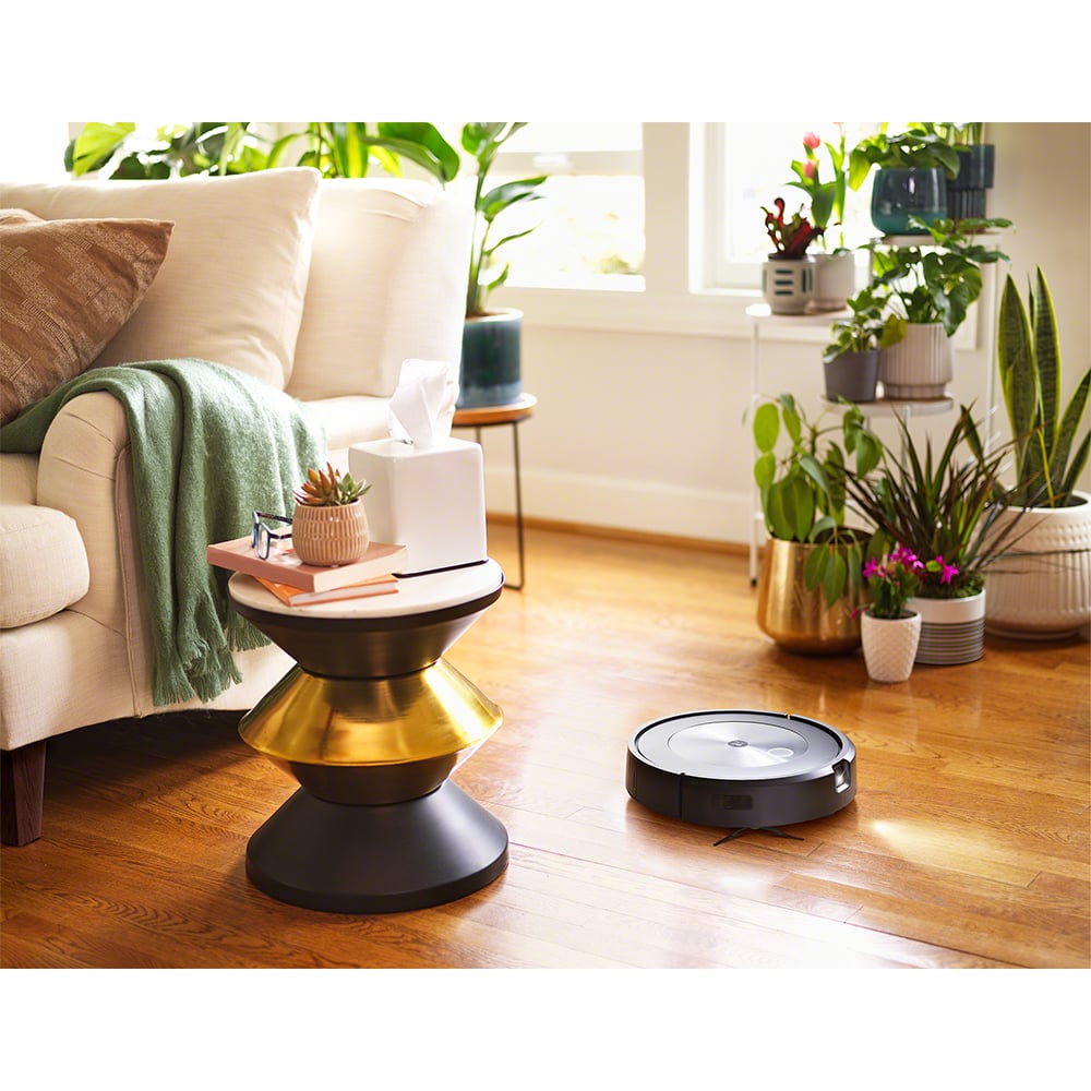 Roomba j7+ Robot Vacuum on a wooden floor in a living room