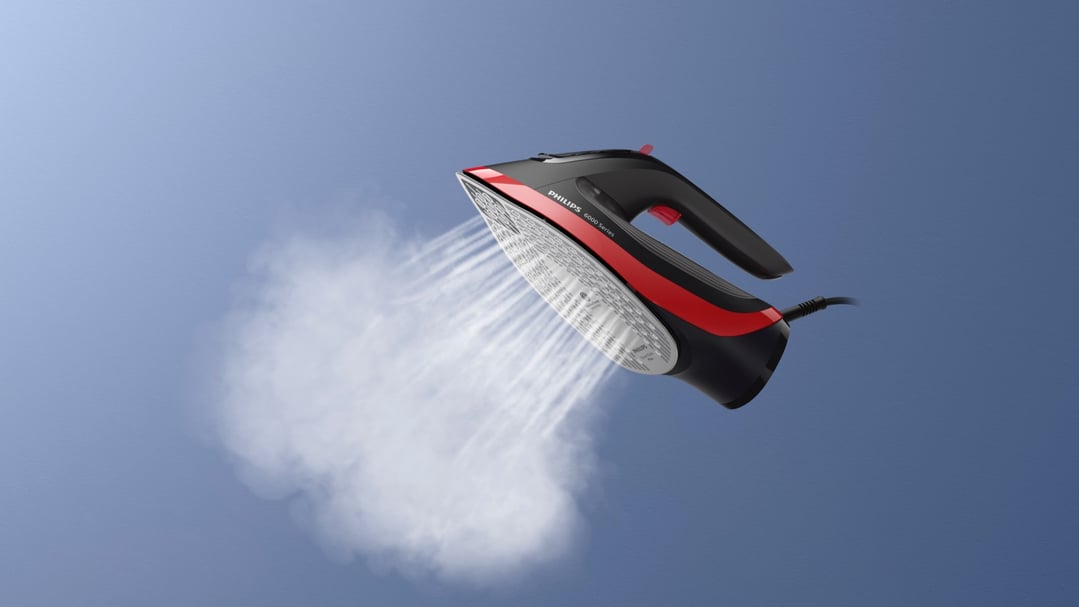 Philips 6000 Series Steam Iron emitting steam against a blue background