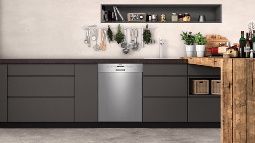 Built-under dishwasher in a modern kitchen with dark cabinets and wooden accents