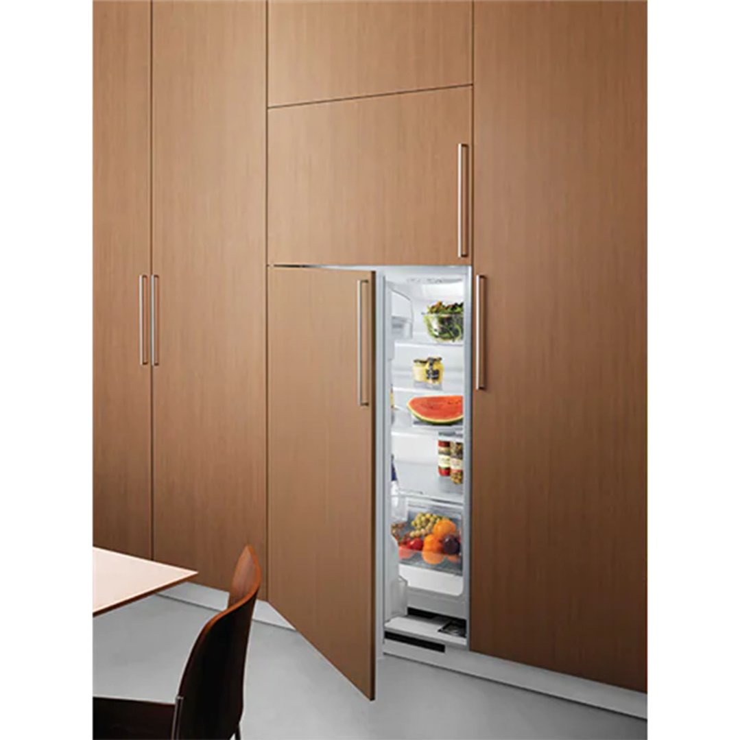 Built-in refrigerator with an open door revealing food, integrated into wooden cabinetry