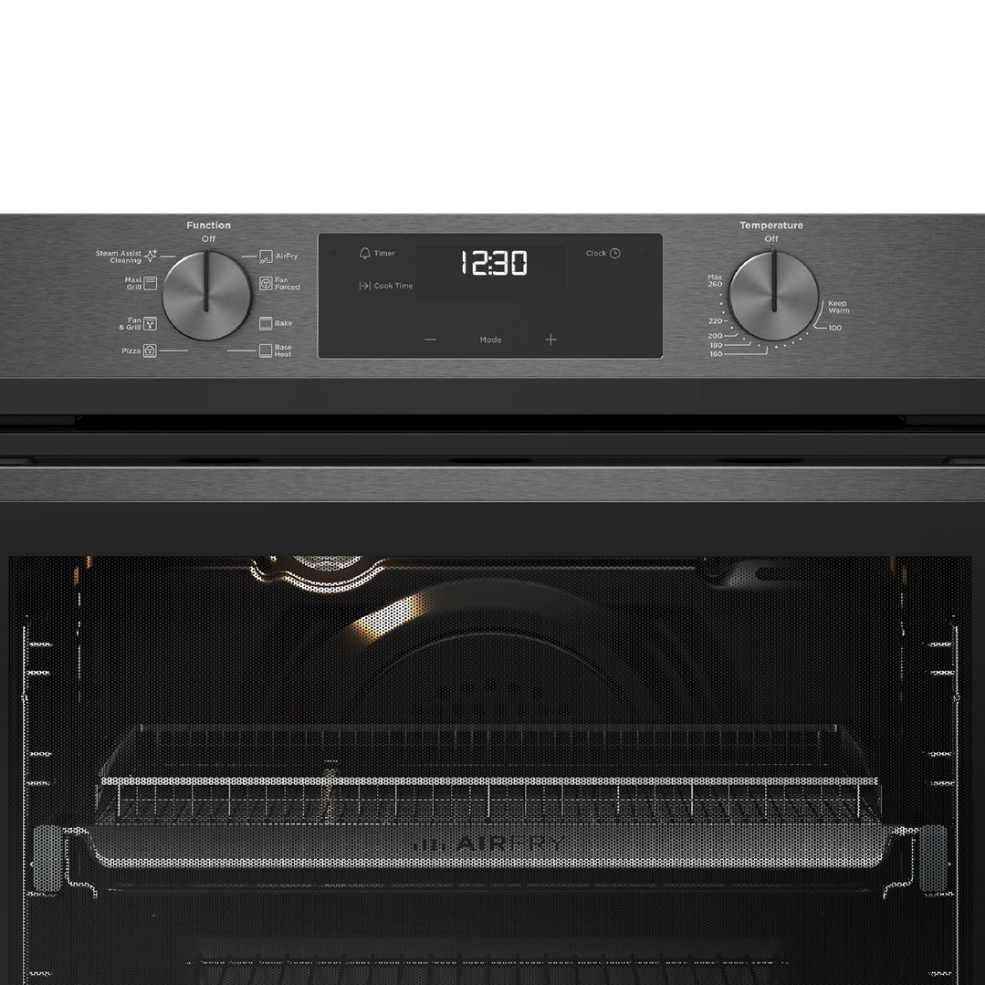 Close up of a dark stainless steel oven with the door open