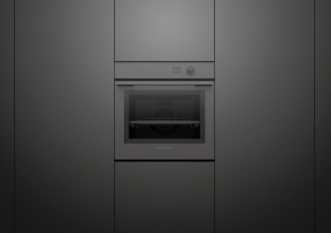 Minimal pyrolytic oven built into dark grey cabinetry in a modern kitchen