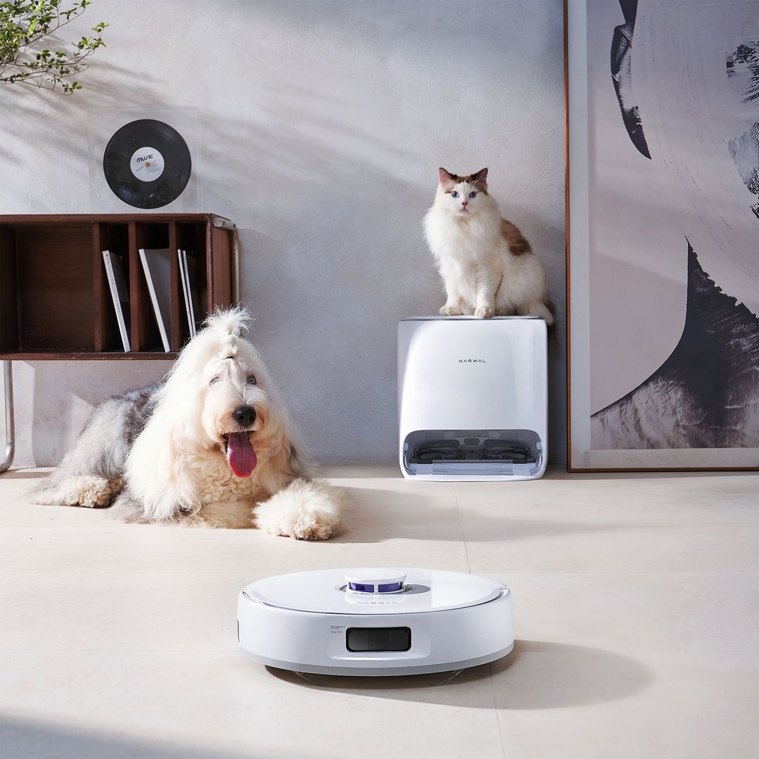 Narwal Freo X Ultra robotic vacuum and mop with dog and cat in a living room