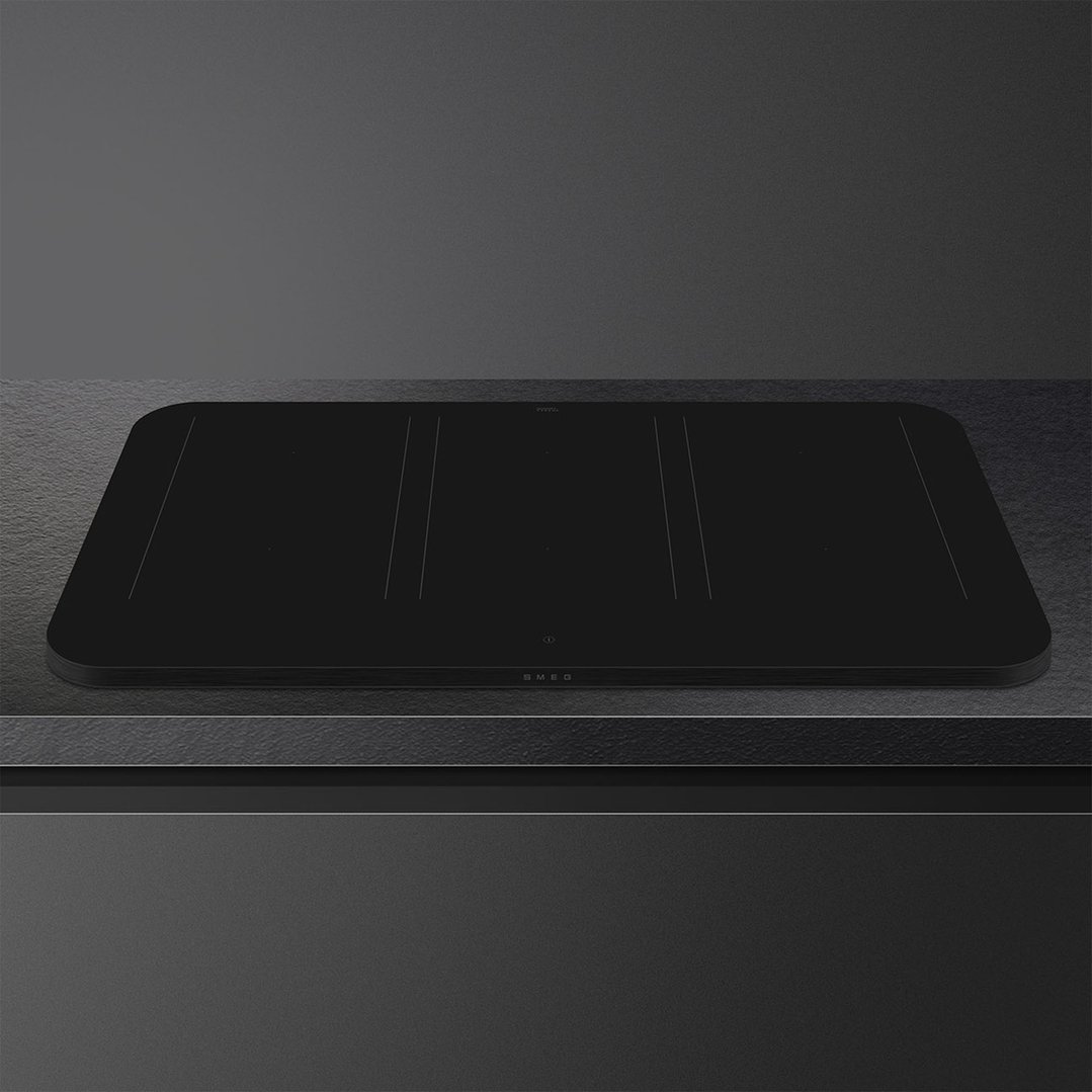 Matte black induction cooktop with controls on a dark countertop