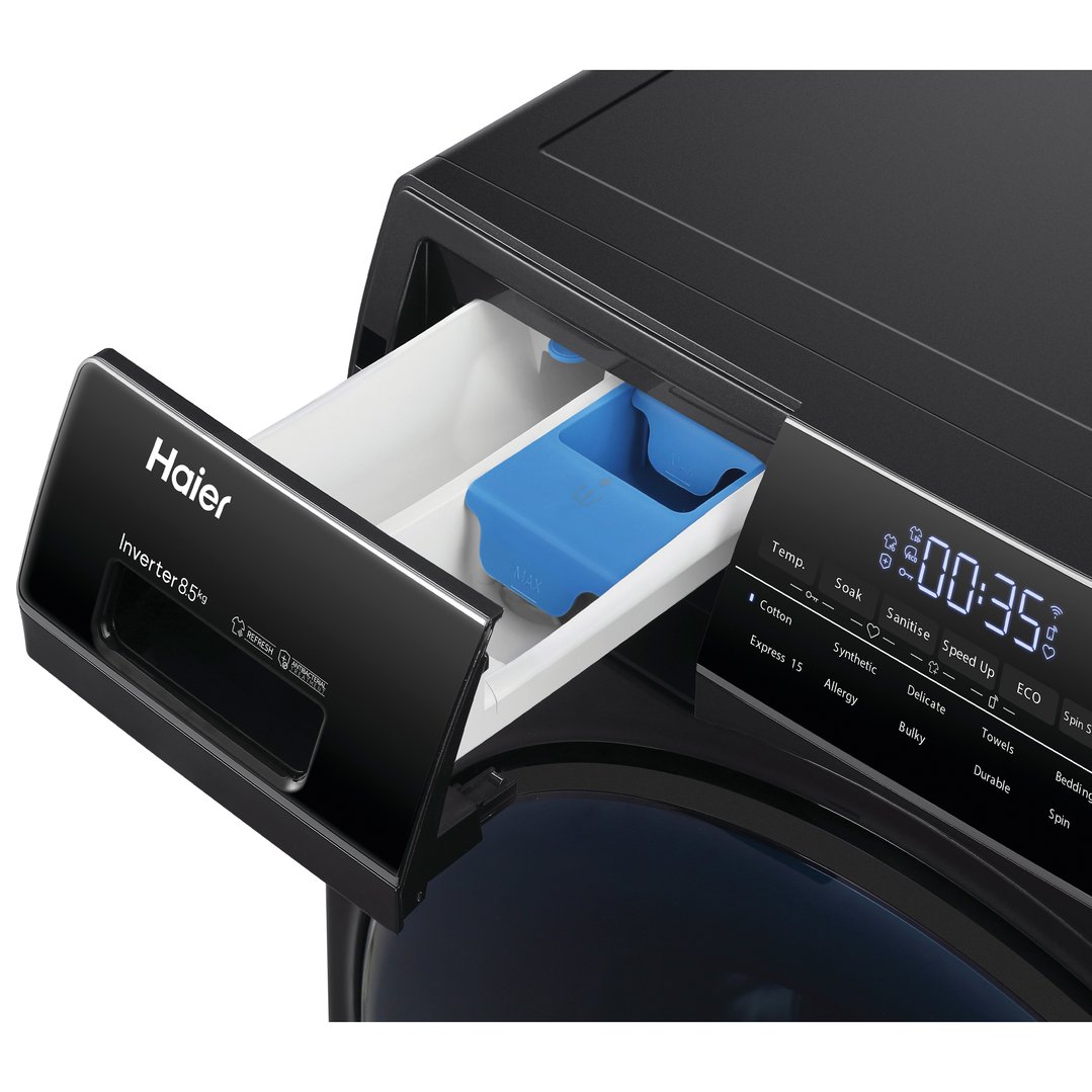 Close up of a black Haier washing machine with the detergent drawer open