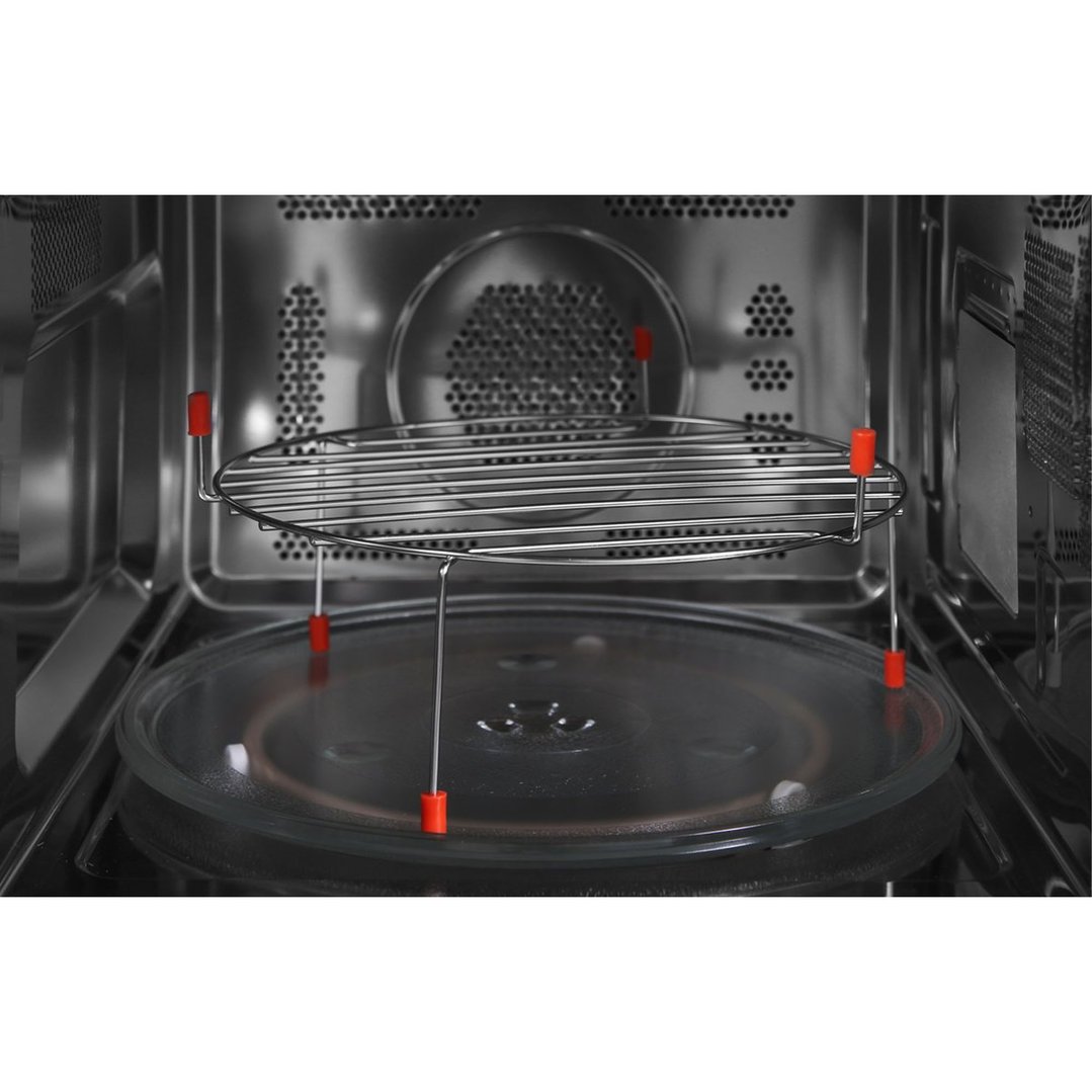 Inside view of a microwave oven with a metal rack and glass turntable