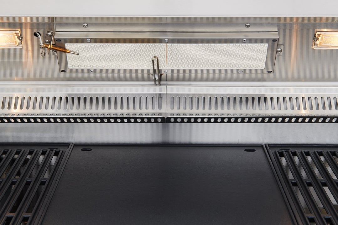 Close up of a stainless steel built-in BBQ with grates and a griddle