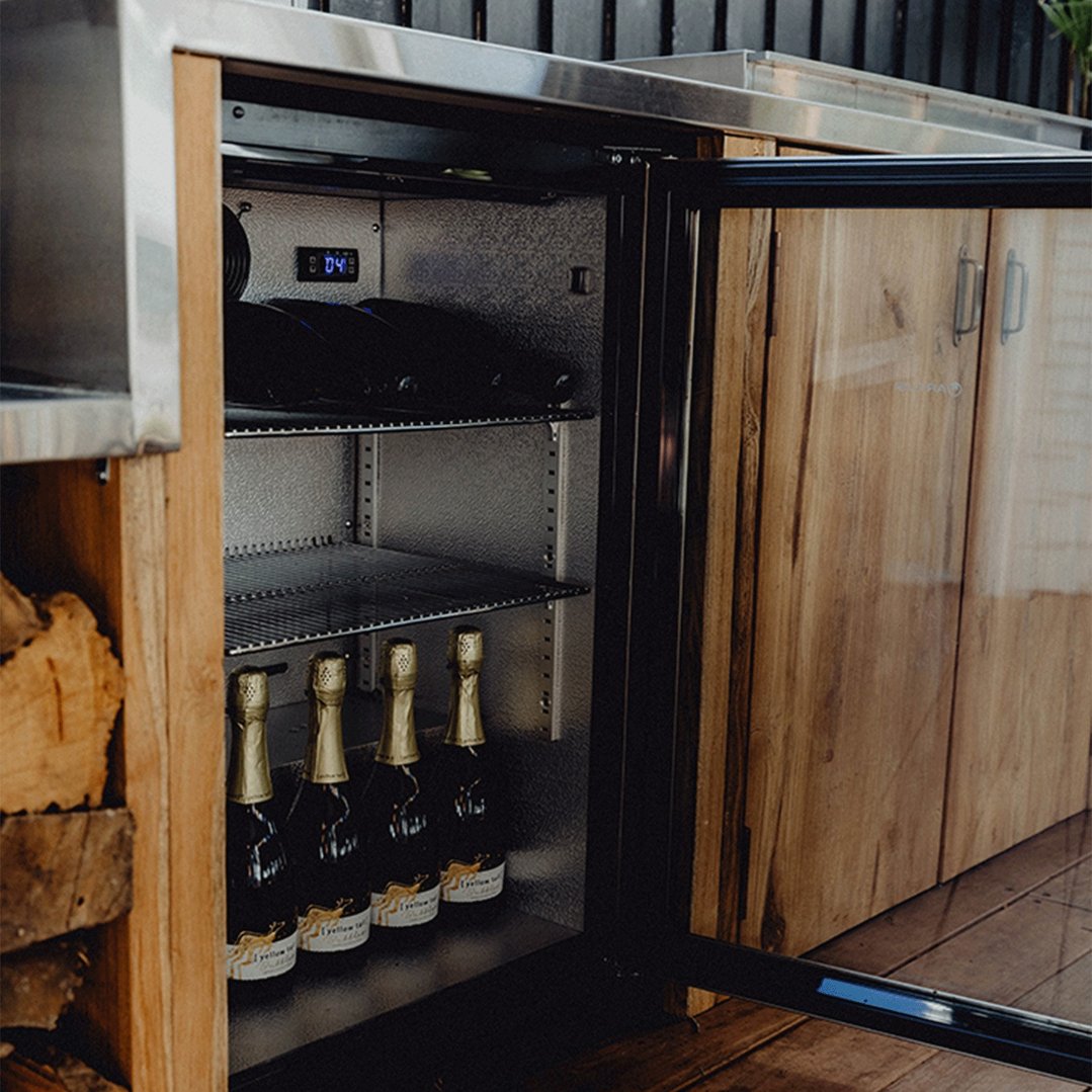 Outdoor beverage centre with glass door open, showing bottles inside