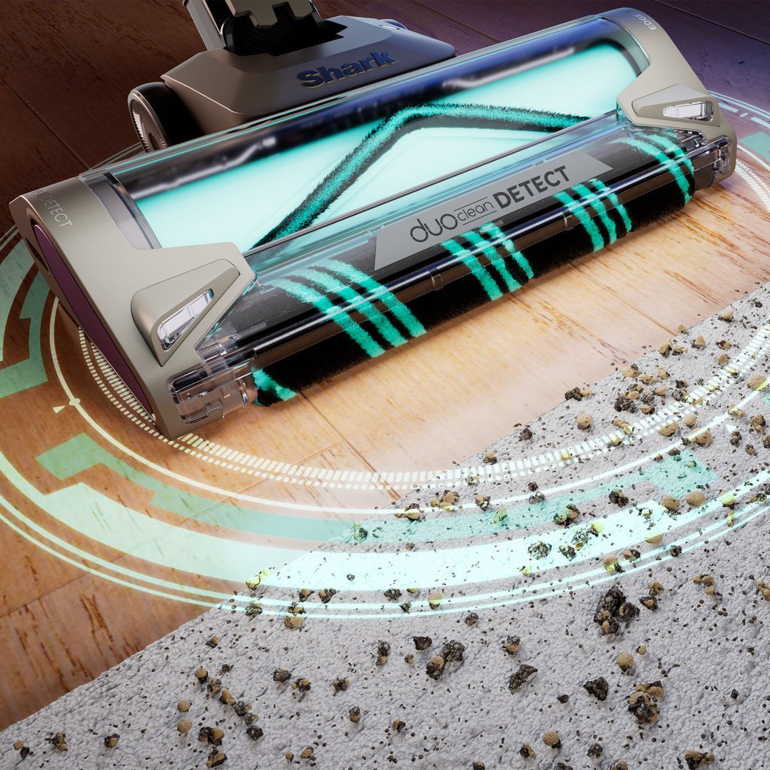 Cordless vacuum cleaner head cleaning a floor with dirt and debris