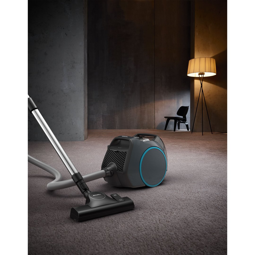Miele Boost CX1 Bagless Vacuum Cleaner on carpet in a living room