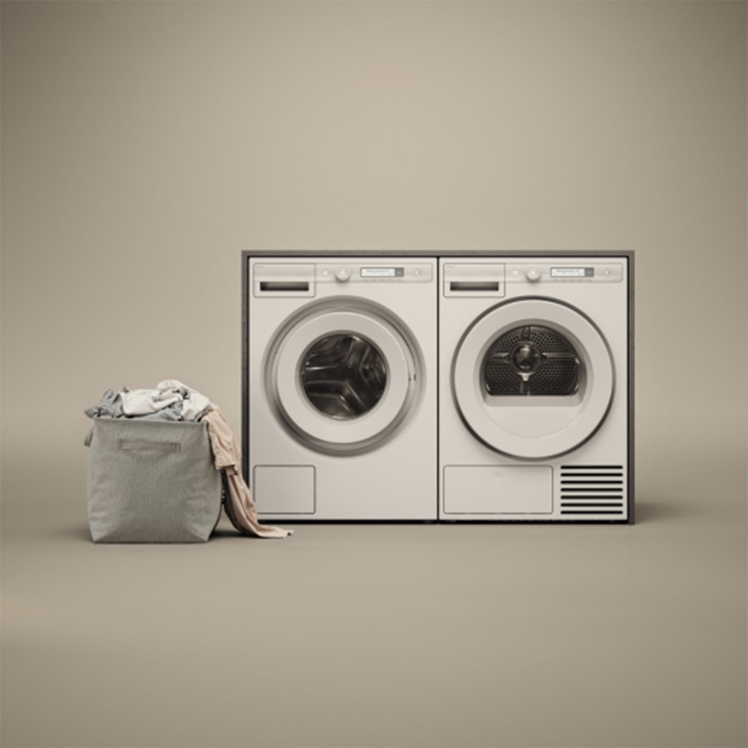 Front load washing machine and dryer with a laundry basket on a neutral background
