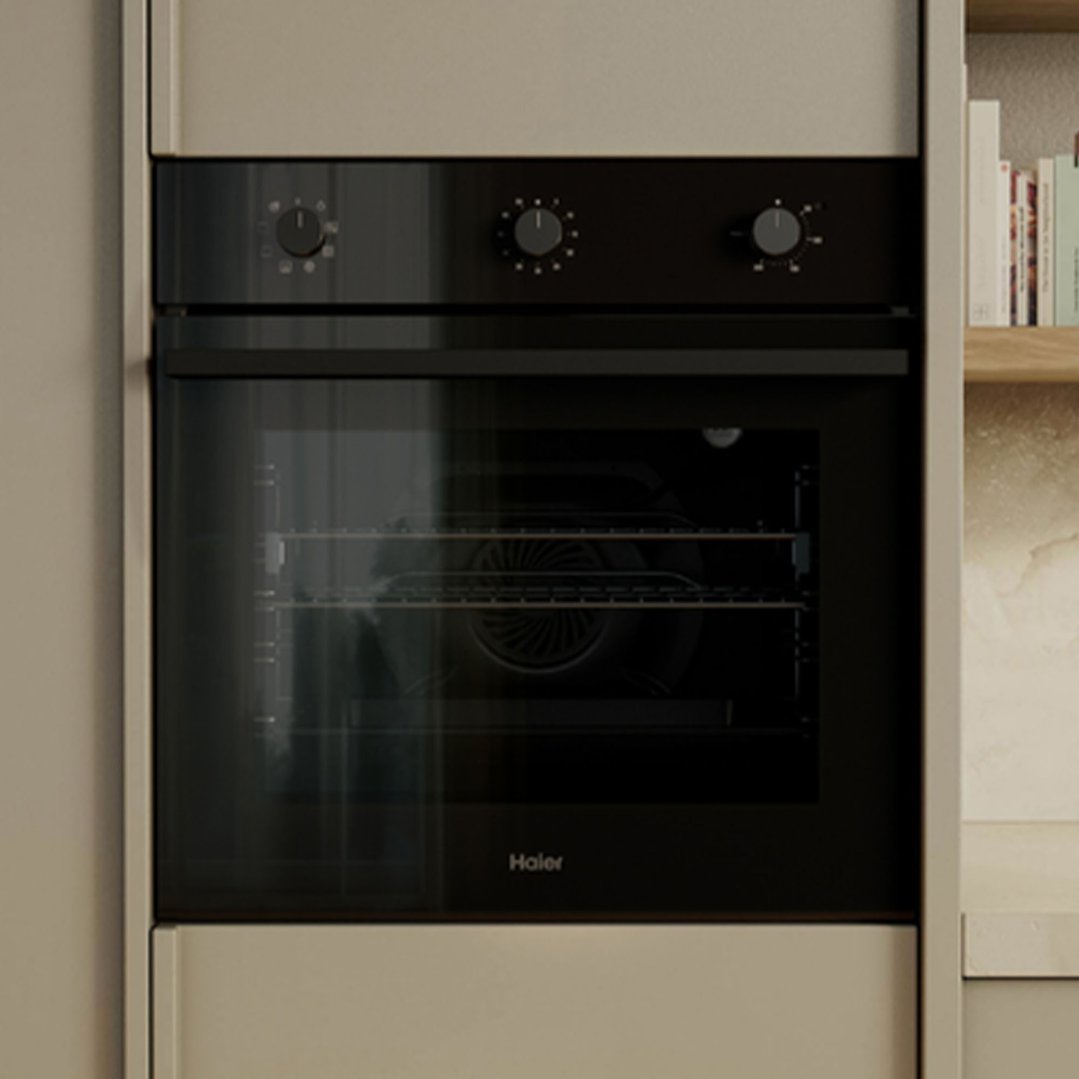 Black built-in oven with three control knobs in a modern kitchen setting