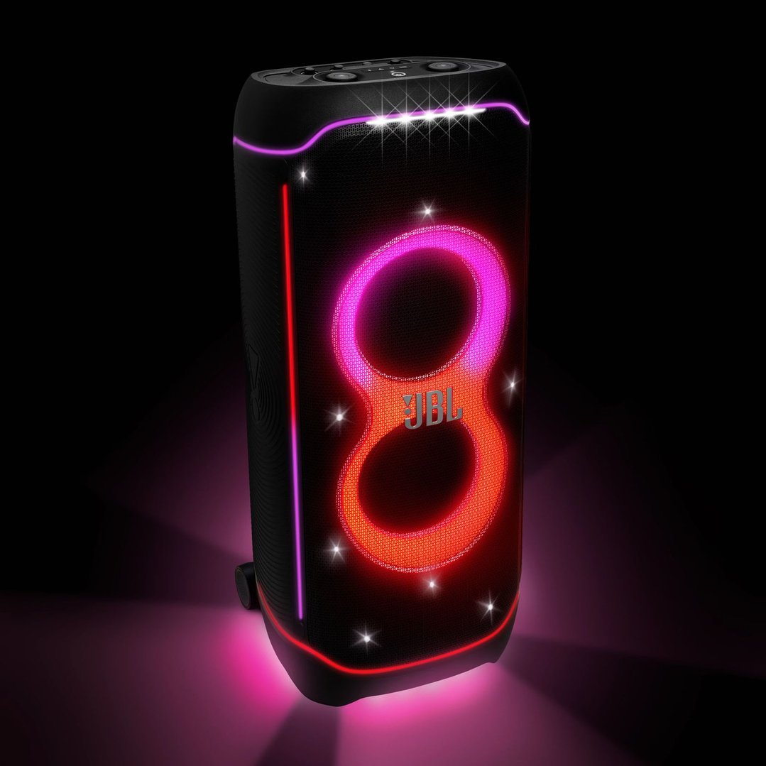 JBL Partybox Ultimate hifi system with glowing lights in a dark setting