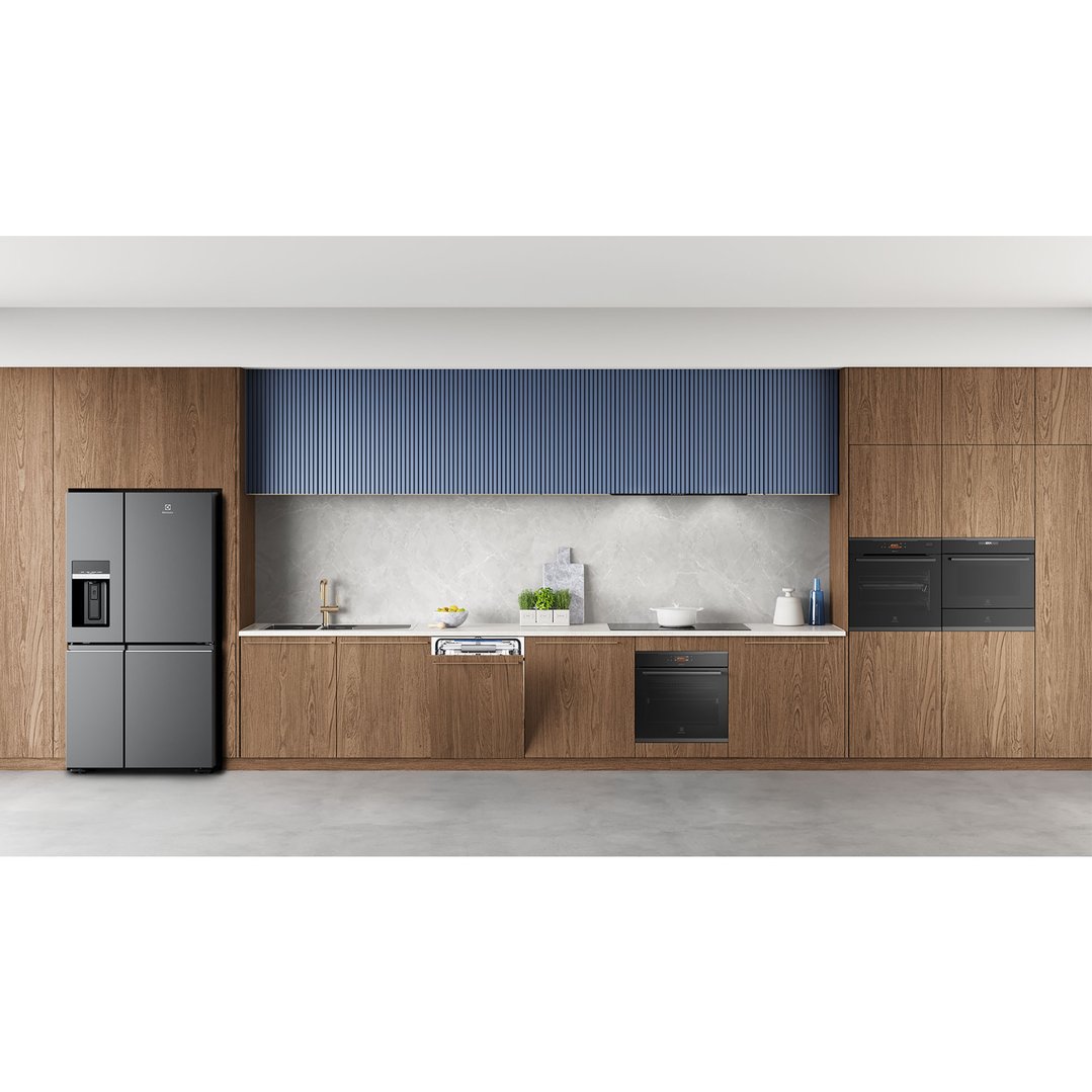 Modern kitchen with built-in ovens, refrigerator, dishwasher, and sink