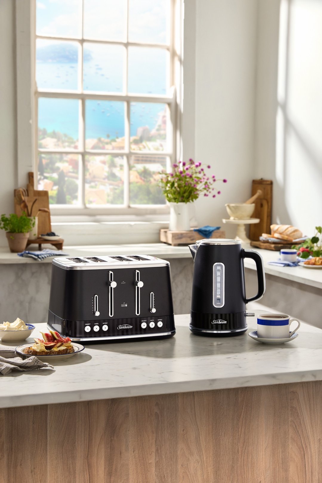 Black 4-slice toaster and kettle on a kitchen counter with food