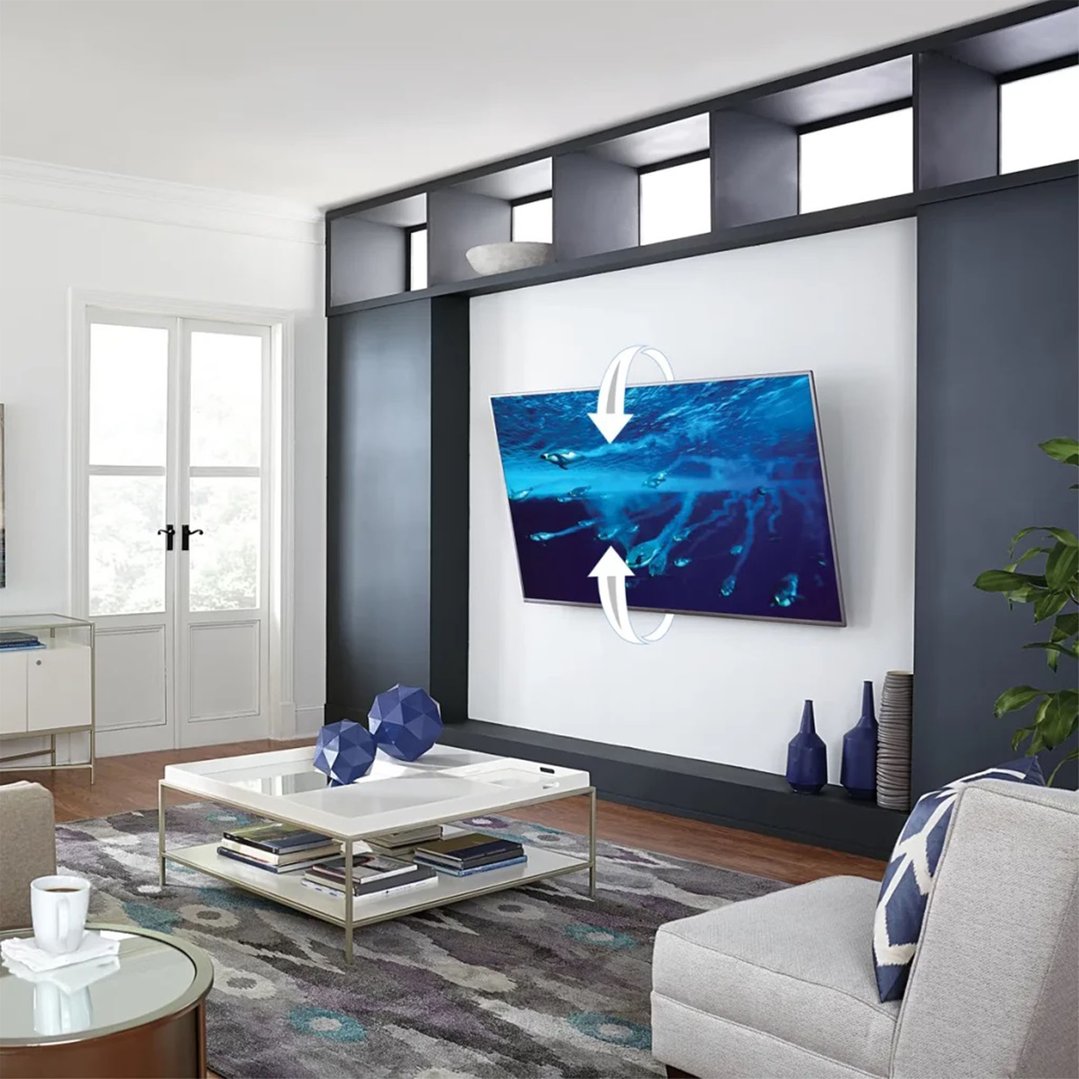 A TV wall mount shown with a TV in a modern living room setting