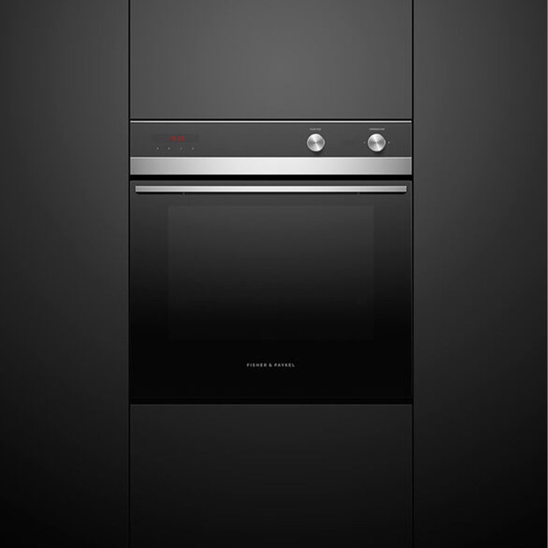 Built-in Fisher & Paykel Series 5 oven with a black finish in a dark kitchen