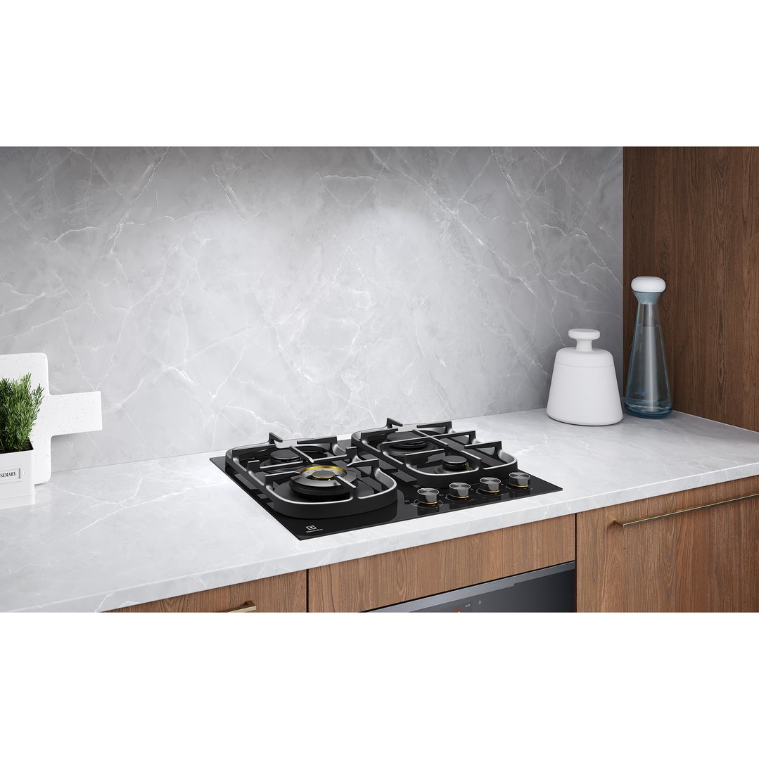 Electrolux 60cm gas cooktop built into a kitchen counter with marble backsplash