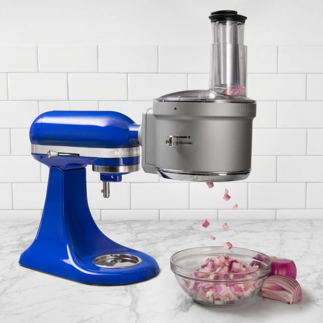 Food Processor Attachment on a blue stand mixer dicing red onion
