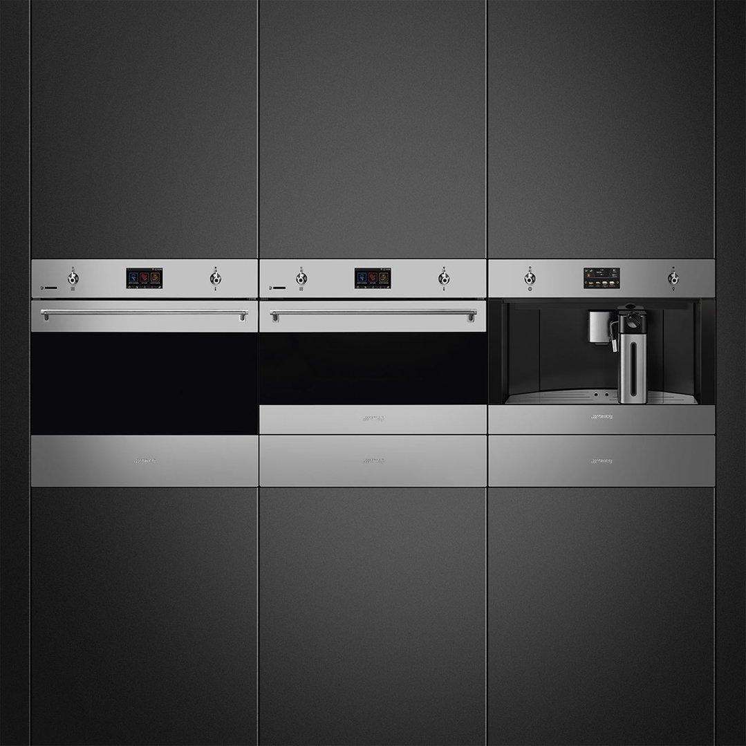 Built-in coffee machine with two ovens in a dark kitchen cabinet setting