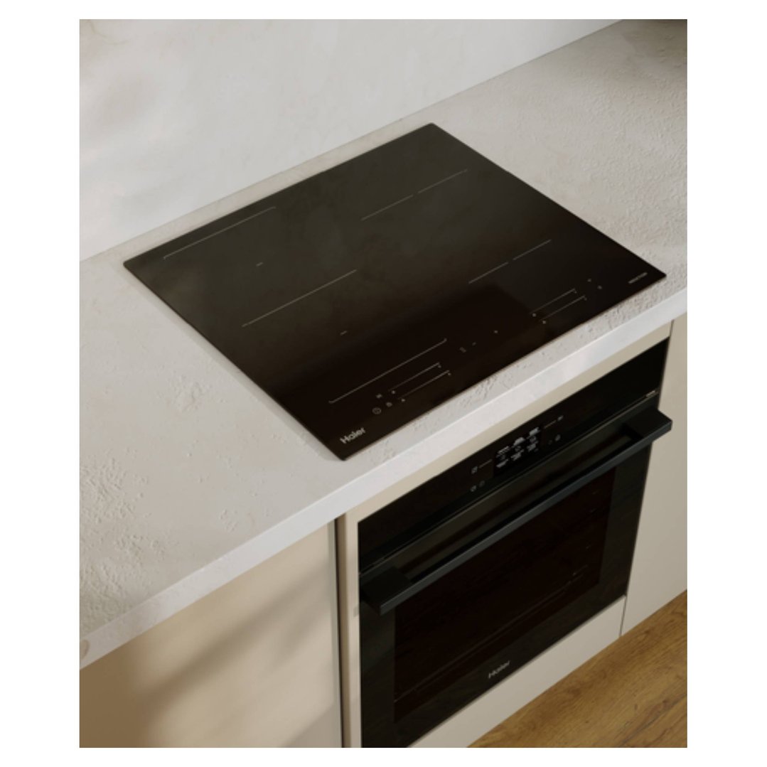 Haier induction cooktop and oven built into a light-colored kitchen counter
