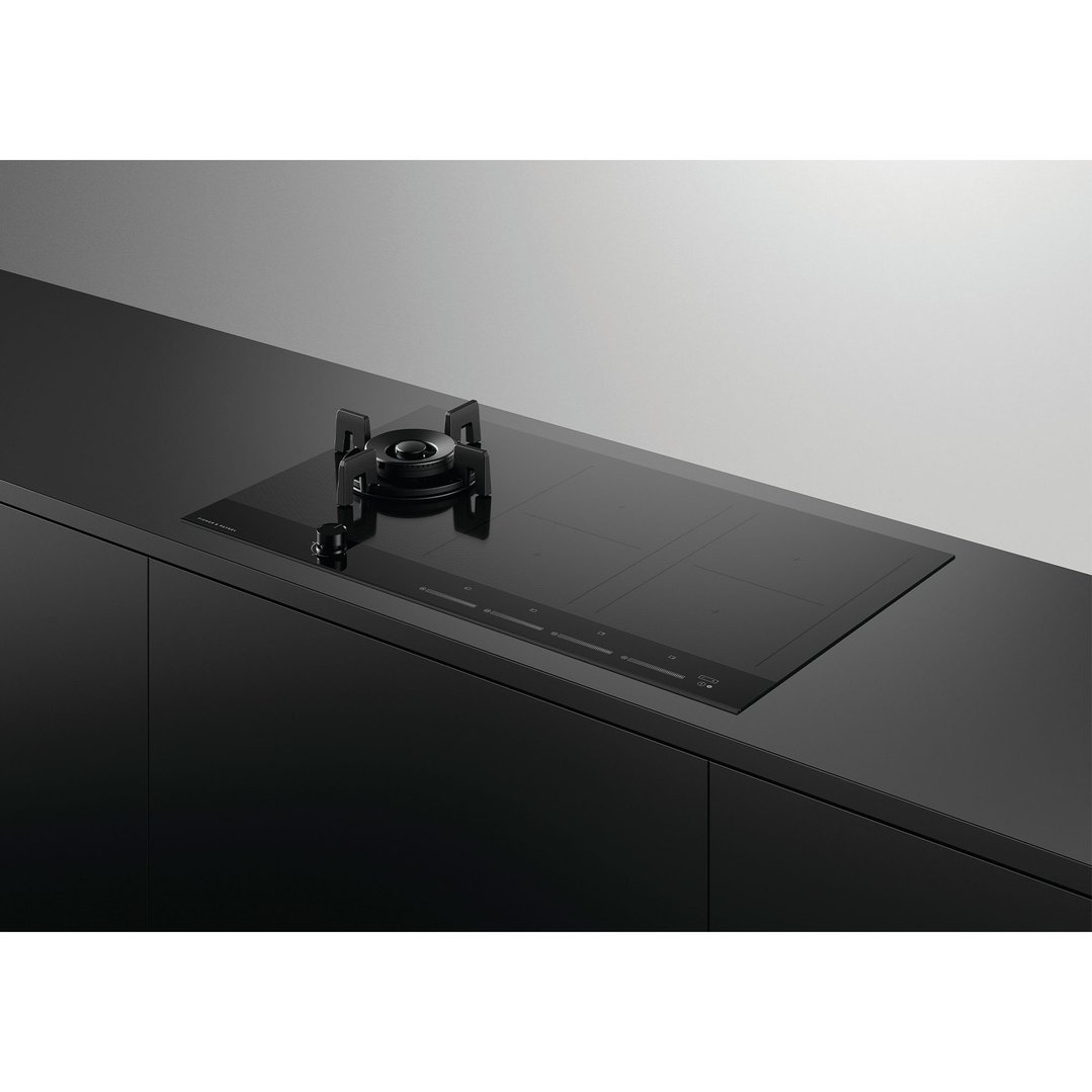 Black hybrid cooktop with one gas burner and four induction zones in a modern kitchen