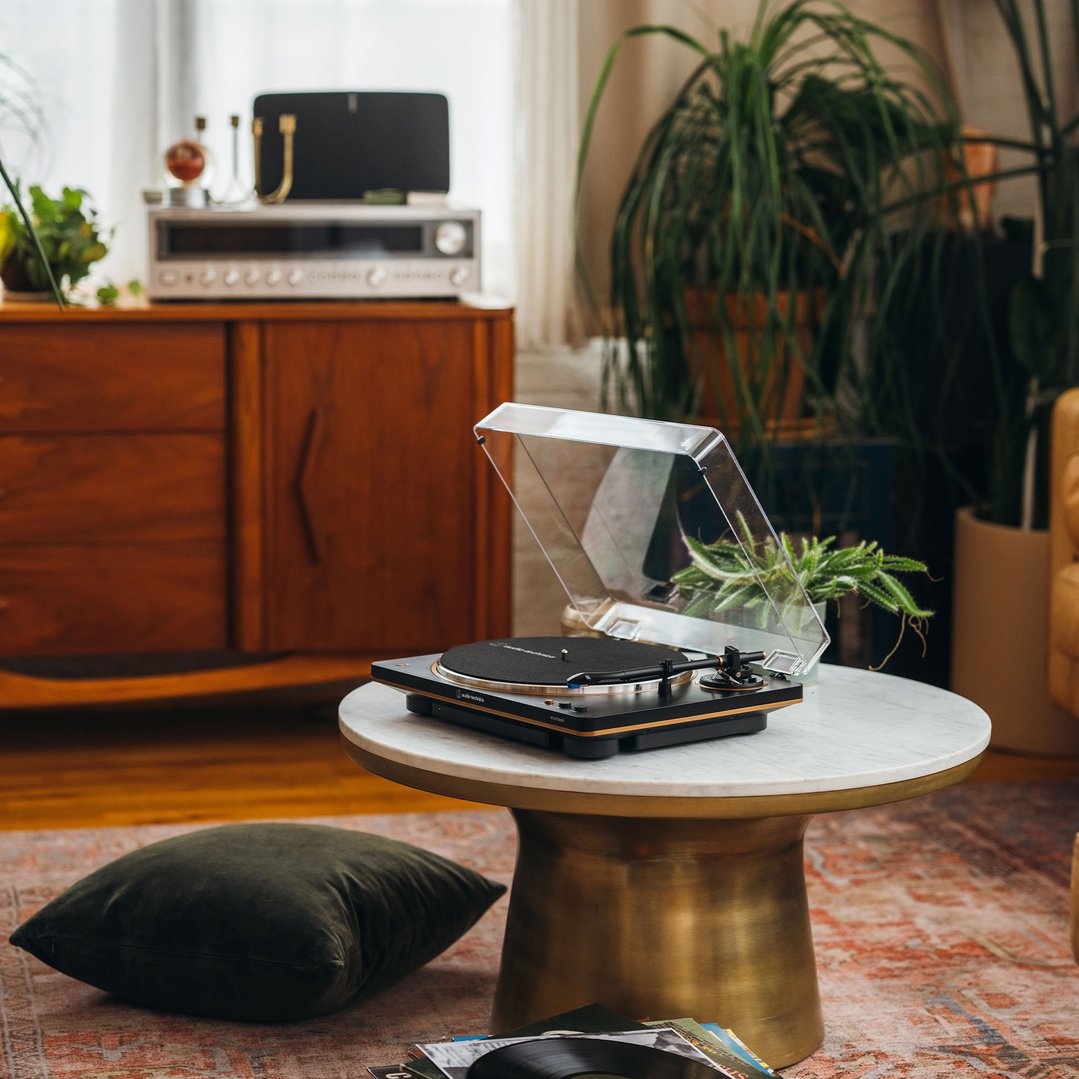 AUDIO-TECHNICA Bluetooth Fully Automatic Belt-Drive Turntable on a marble coffee table