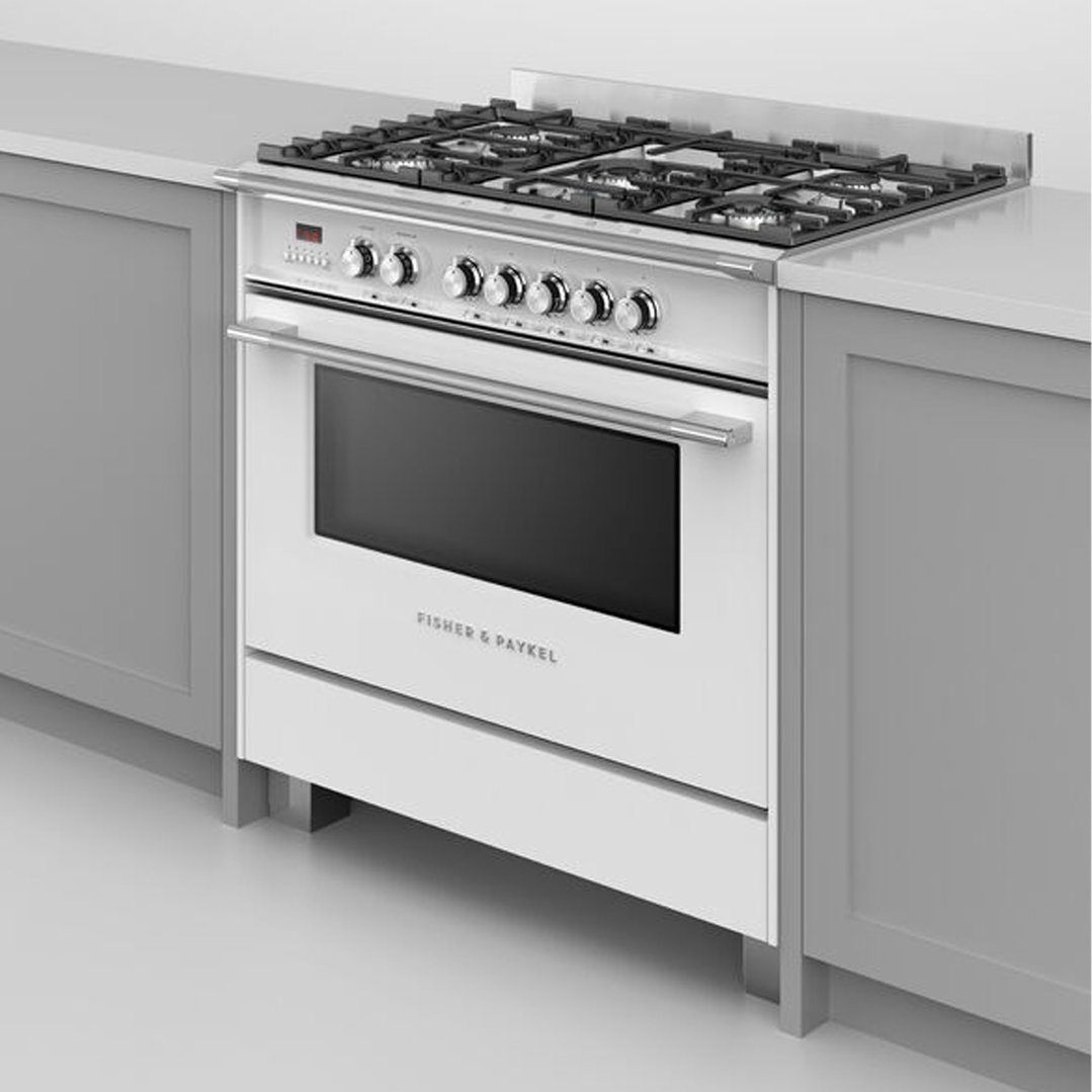 White freestanding oven with gas cooktop in a modern kitchen setting
