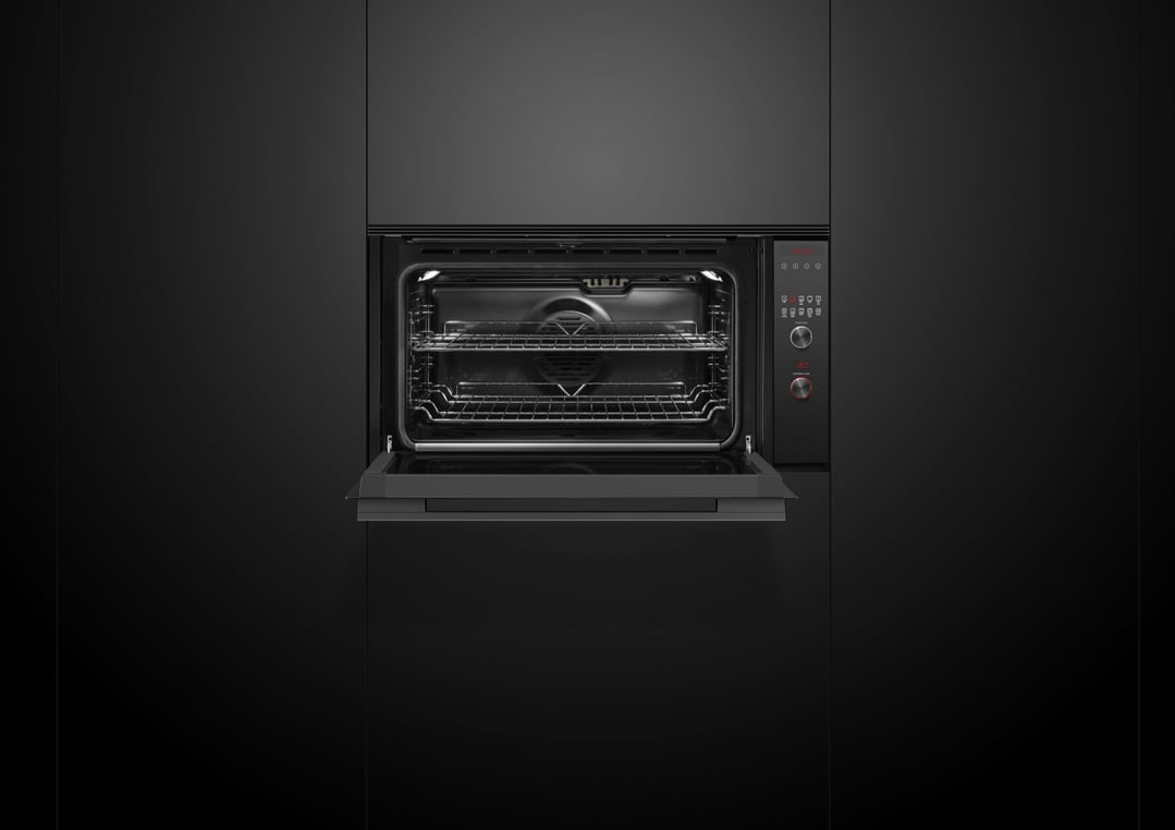 Black built-in oven with the door open, showing the interior racks