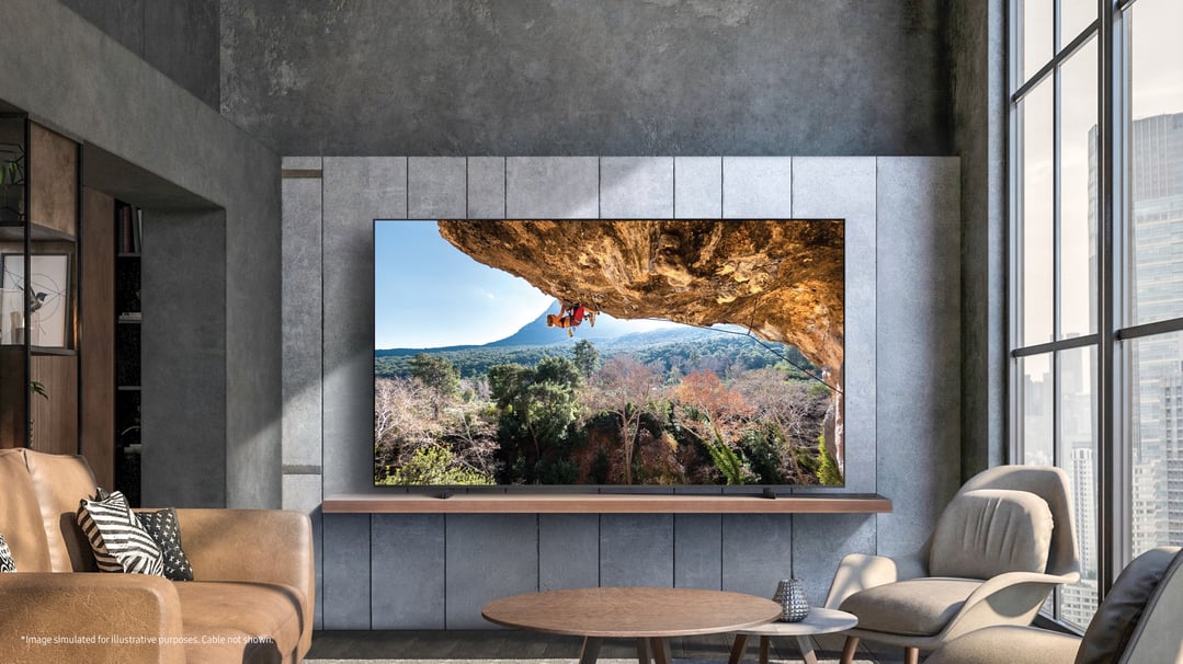 A large Samsung Crystal UHD 4K Smart TV displaying a rock climber