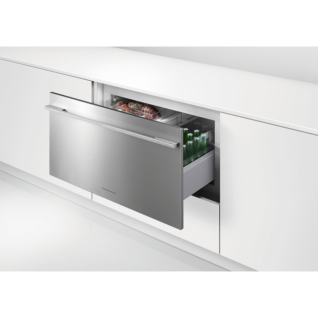 Integrated CoolDrawer Multi-temperature Drawer partially open in a white kitchen