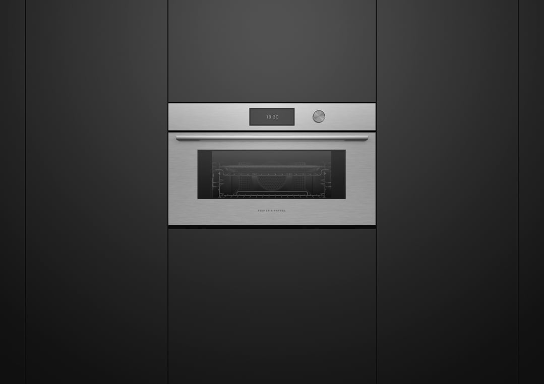 Brushed silver compact combi-steam oven built into dark cabinetry