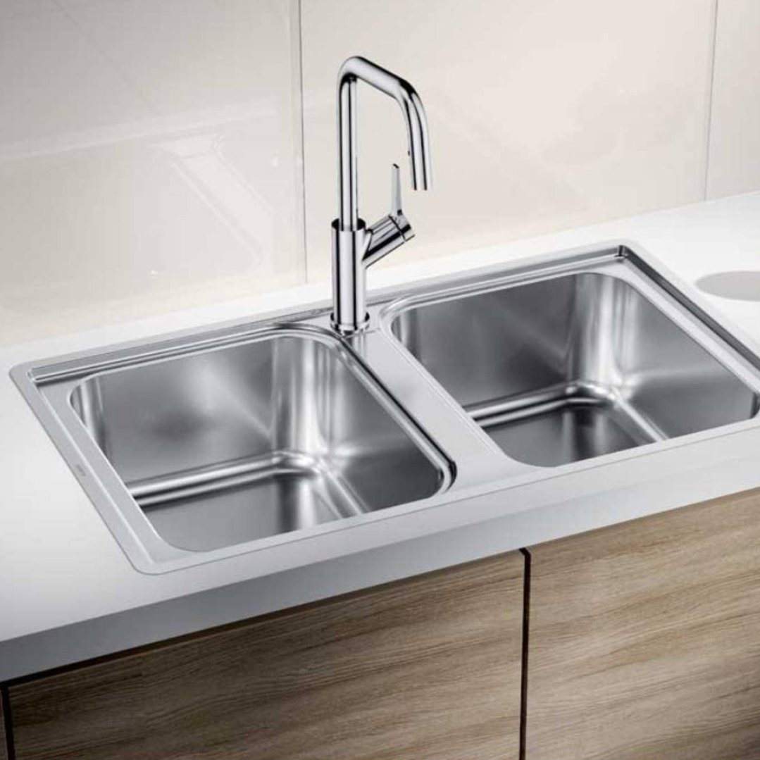 Double bowl inset/flushmount sink with a chrome faucet in a modern kitchen