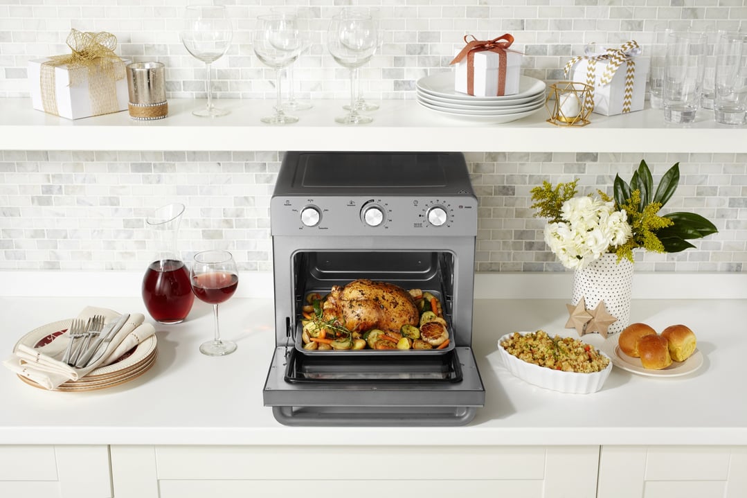 Multi Function Oven + Air Fryer on a kitchen counter with food and decorations