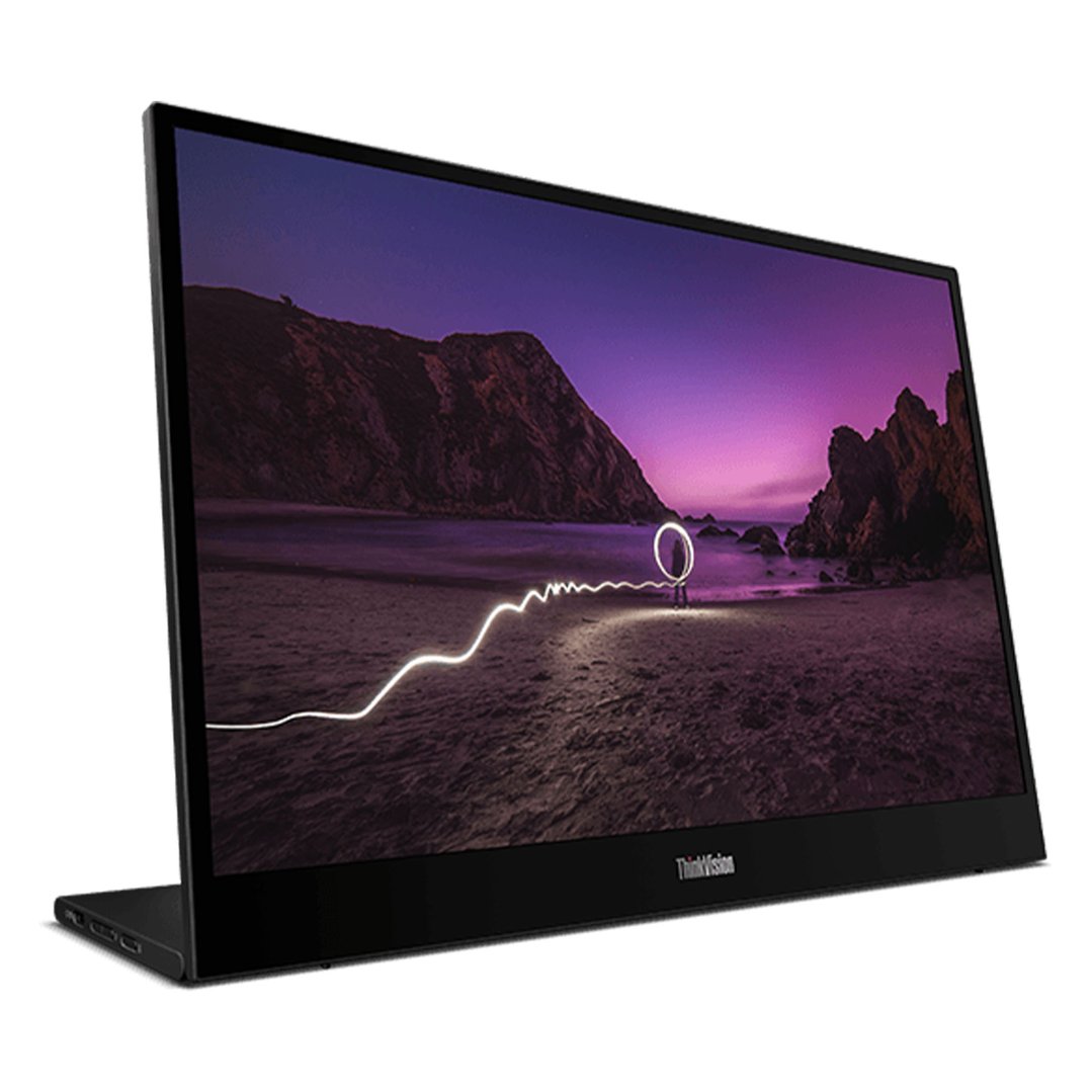 A monitor displaying a night beach scene with light painting, angled view