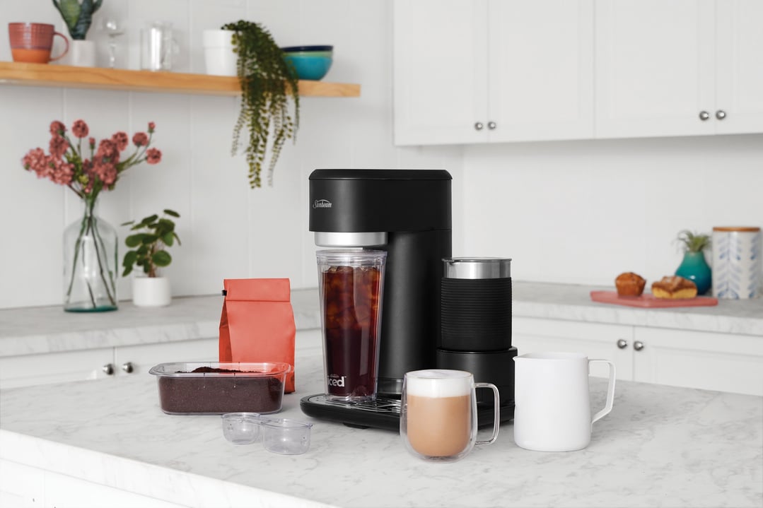 Black coffee machine with iced coffee and latte on a kitchen counter
