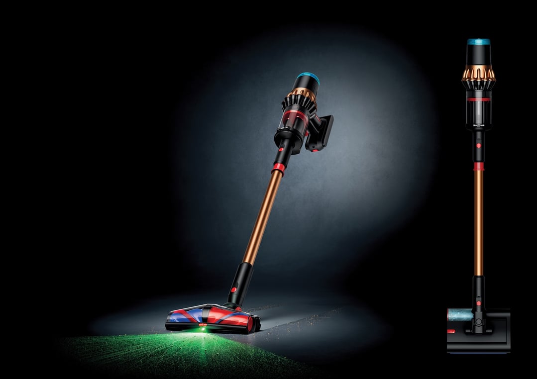 Dyson handstick vacuum with illuminated head cleaning a dark floor