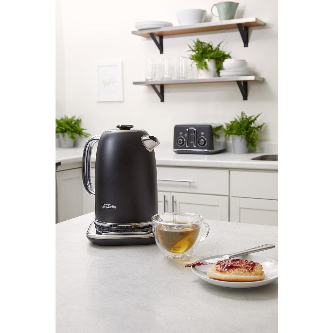 Black Sunbeam kettle on a kitchen counter with tea and toast