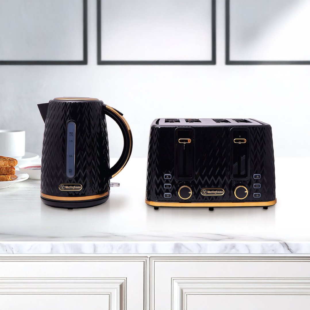 Black and gold kettle and toaster on a white marble countertop