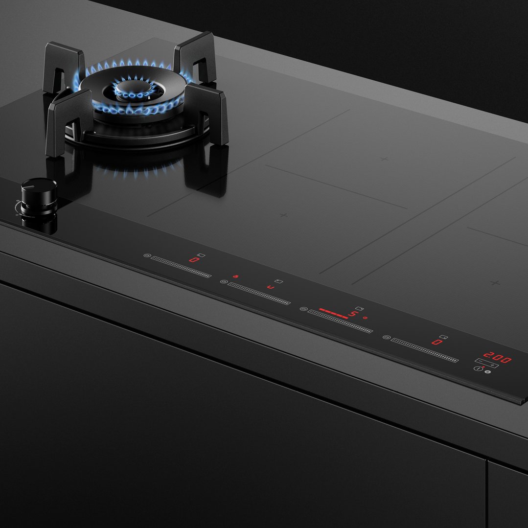 Close-up of a black hybrid cooktop with gas burner and induction zones