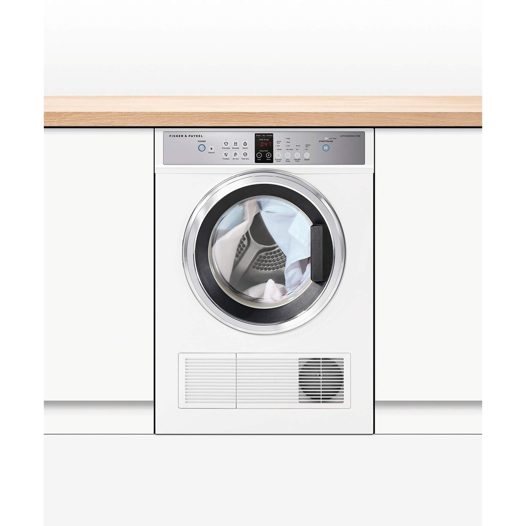 A white Fisher & Paykel vented dryer installed under a wooden countertop