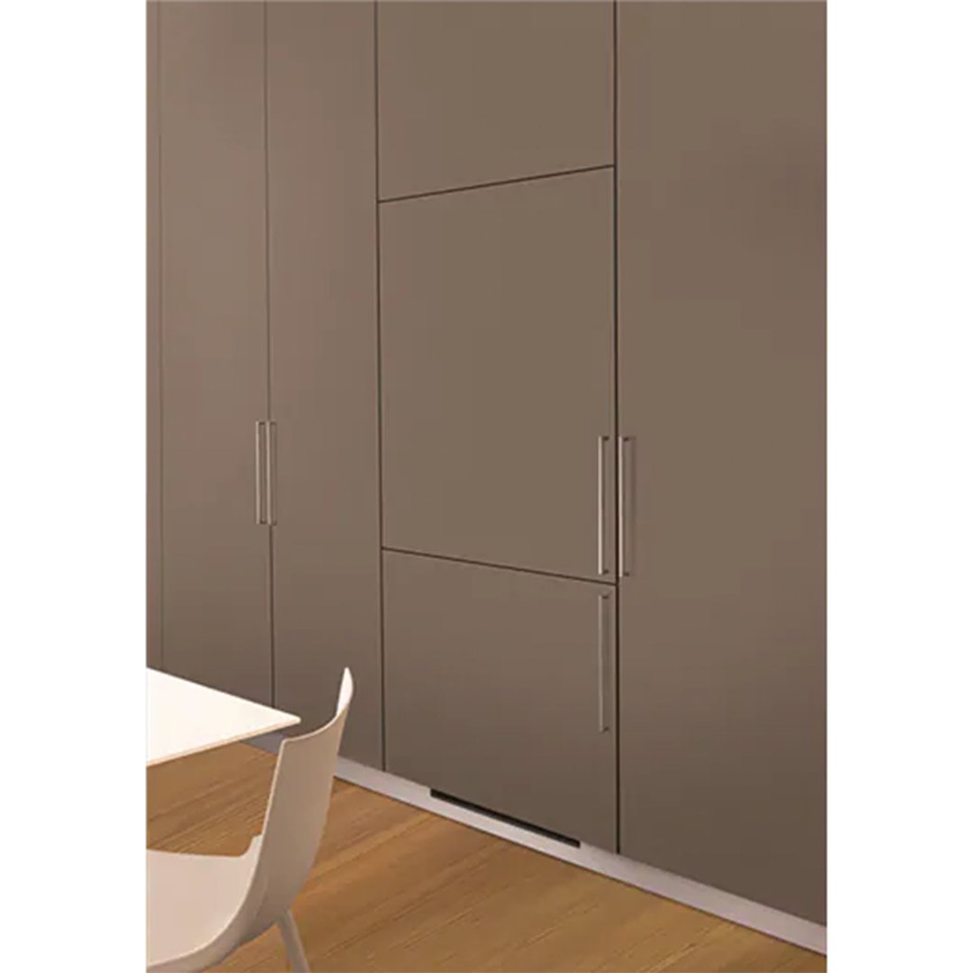 Built-in refrigerator integrated into a wall of brown cabinets in a modern kitchen