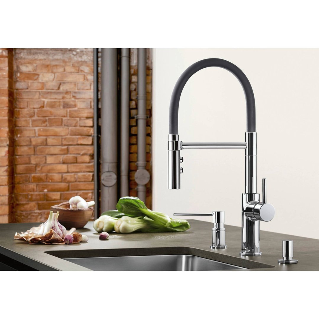 Chrome mixer tap with a black flexible hose in a kitchen setting with vegetables