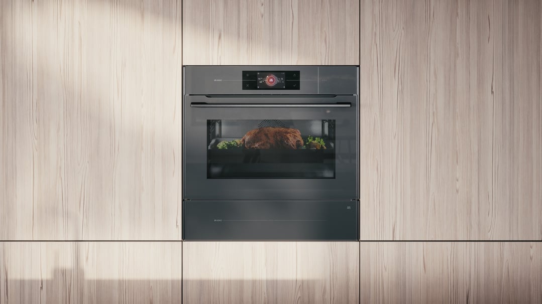 A built-in combi steam microwave oven with a roasted chicken inside, in a kitchen