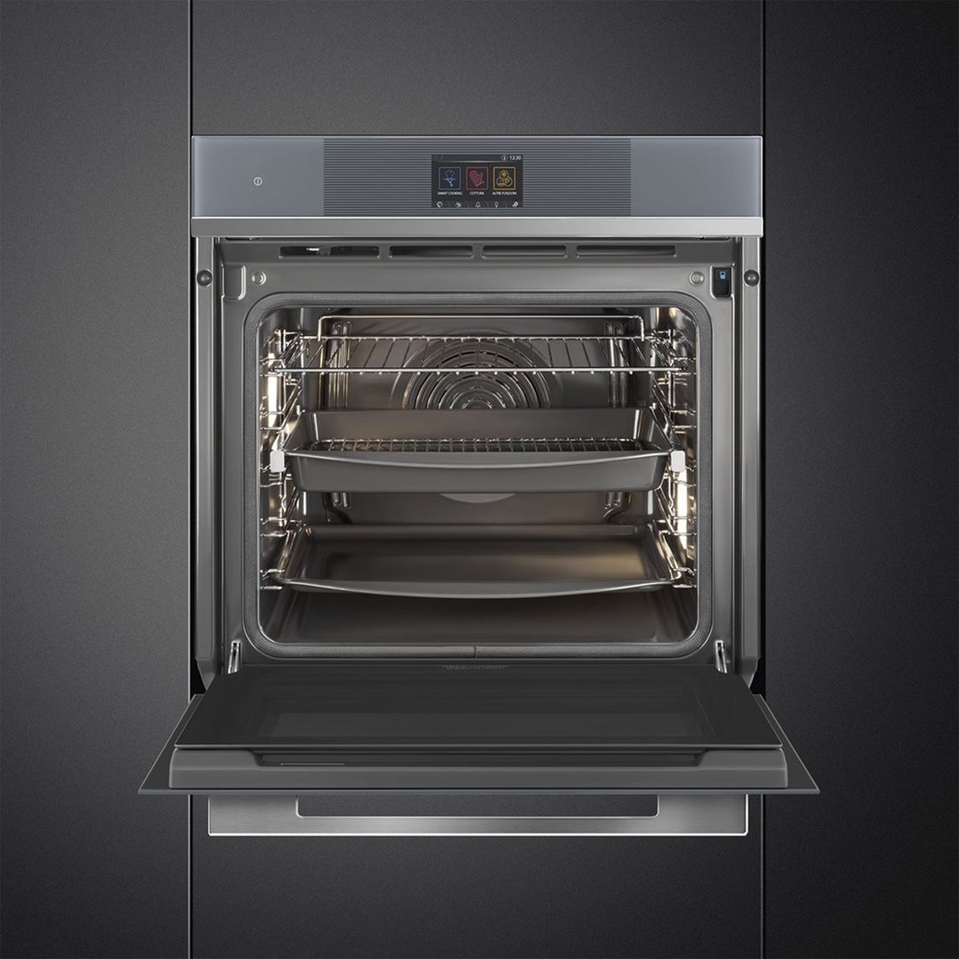 Built-in oven with door open, showing interior racks and baking trays