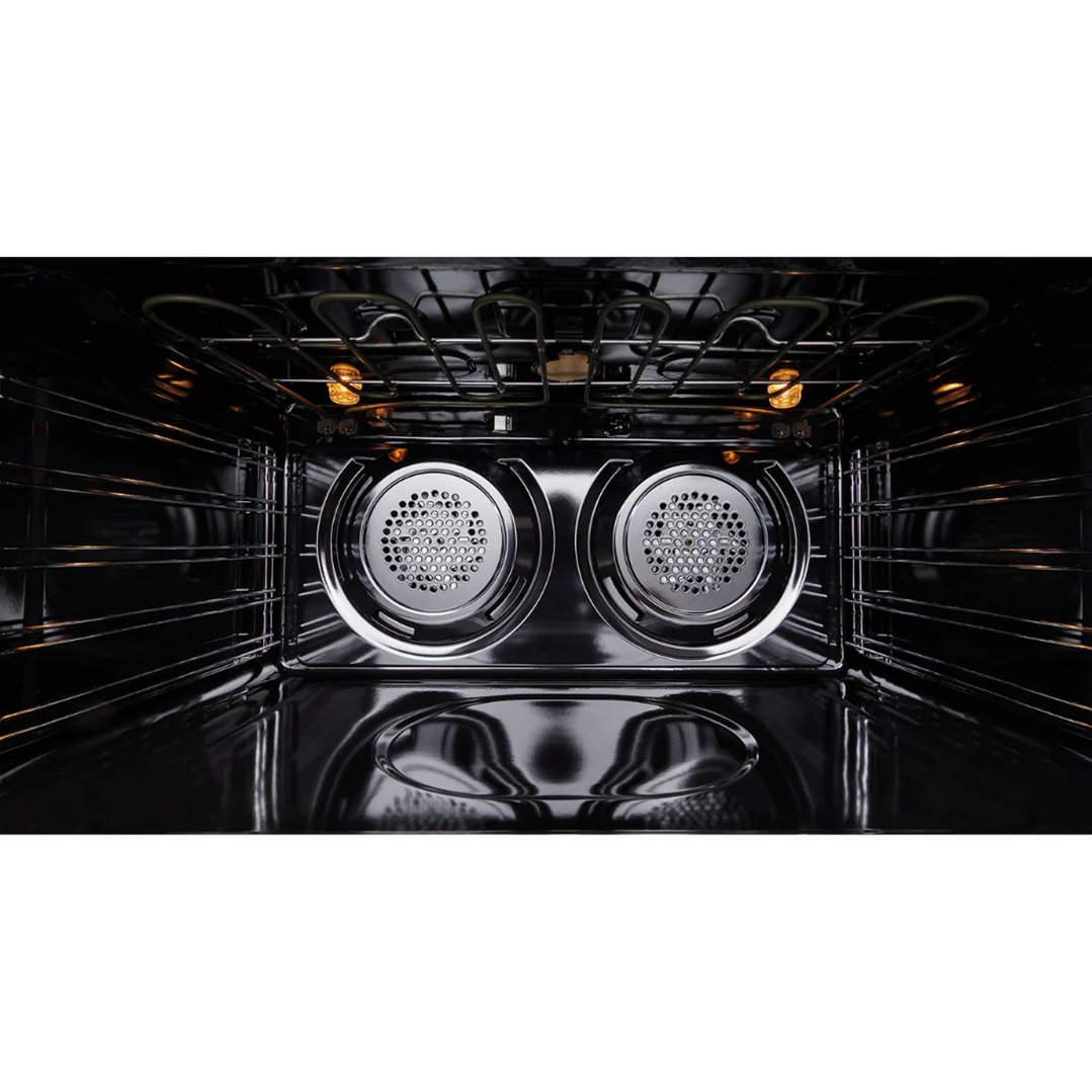 Interior view of a dual fuel freestanding oven with lights on