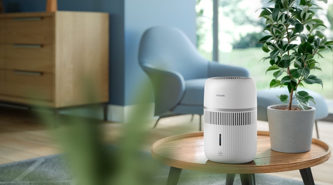 White Philips Air Humidifier on a wooden table in a living room